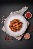 Delicious crispy potato wedges with garlic, salt, spices and herbs photo