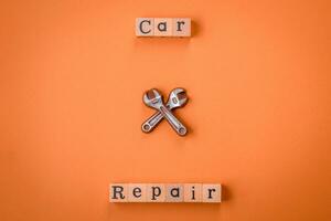 Tools and inscriptions symbolizing repairs or a garage and its attributes on a plain background photo