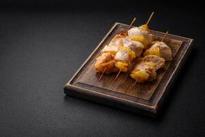 Delicious chicken or turkey kebab with pineapple pieces on skewers photo