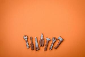 Tools and inscriptions symbolizing repairs or a garage and its attributes on a plain background photo