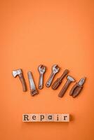 Tools and inscriptions symbolizing repairs or a garage and its attributes on a plain background photo