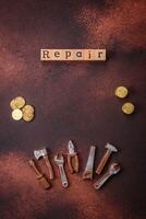 Tools and inscriptions symbolizing repairs or a garage and its attributes on a plain background photo