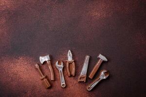 Tools and inscriptions symbolizing repairs or a garage and its attributes on a plain background photo