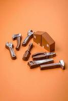 Repair or home improvement tools and a house model on a plain background photo