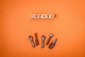 Tools and inscriptions symbolizing repairs or a garage and its attributes on a plain background photo