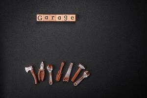 Tools and inscriptions symbolizing repairs or a garage and its attributes on a plain background photo