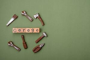 Tools and inscriptions symbolizing repairs or a garage and its attributes on a plain background photo