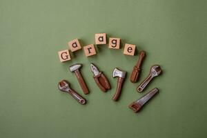 Tools and inscriptions symbolizing repairs or a garage and its attributes on a plain background photo