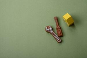 Repair or home improvement tools and a house model on a plain background photo