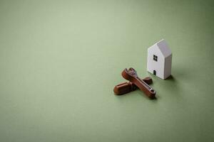 Repair or home improvement tools and a house model on a plain background photo