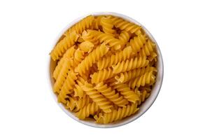 Raw fusilli pasta from whole grain wheat varieties photo