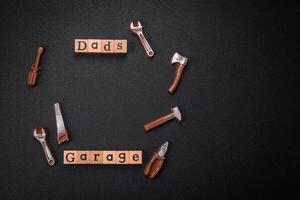 Tools and inscriptions symbolizing repairs or a garage and its attributes on a plain background photo