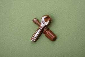 Tools and inscriptions symbolizing repairs or a garage and its attributes on a plain background photo