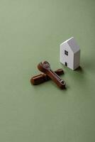 Repair or home improvement tools and a house model on a plain background photo