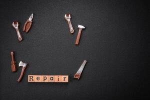 Tools and inscriptions symbolizing repairs or a garage and its attributes on a plain background photo