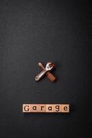 Tools and inscriptions symbolizing repairs or a garage and its attributes on a plain background photo