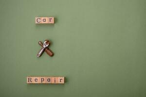 Tools and inscriptions symbolizing repairs or a garage and its attributes on a plain background photo