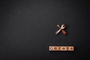 Tools and inscriptions symbolizing repairs or a garage and its attributes on a plain background photo