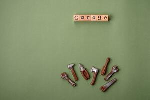 Tools and inscriptions symbolizing repairs or a garage and its attributes on a plain background photo