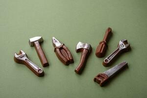 Tools and inscriptions symbolizing repairs or a garage and its attributes on a plain background photo