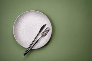 Empty round ceramic plate on a plain background, flatley with copy space photo