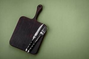 Empty wooden rectangular cutting board on a plain background, flatley with copy space photo