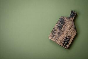 Empty wooden rectangular cutting board on a plain background, flatley with copy space photo