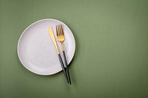 Empty round ceramic plate on a plain background, flatley with copy space photo