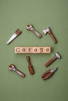 Tools and inscriptions symbolizing repairs or a garage and its attributes on a plain background photo