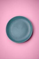 Empty round ceramic plate on a plain background, flatley with copy space photo