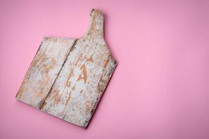 Empty wooden rectangular cutting board on a plain background, flatley with copy space photo