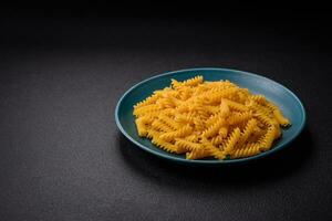 Raw fusilli pasta from whole grain wheat varieties photo