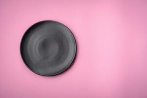 Empty round ceramic plate on a plain background, flatley with copy space photo