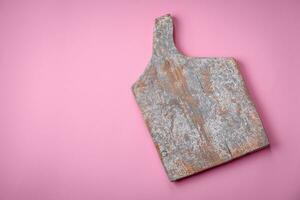 Empty wooden rectangular cutting board on a plain background, flatley with copy space photo