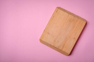 Empty wooden rectangular cutting board on a plain background, flatley with copy space photo