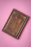Empty wooden rectangular cutting board on a plain background, flatley with copy space photo