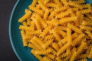 Raw fusilli pasta from whole grain wheat varieties photo