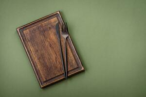 Empty wooden rectangular cutting board on a plain background, flatley with copy space photo