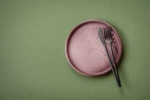 Empty round ceramic plate on a plain background, flatley with copy space photo