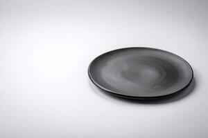 Empty round ceramic plate on a plain background, flatley with copy space photo