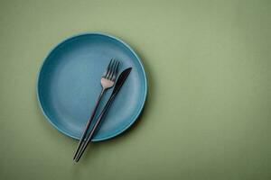 Empty round ceramic plate on a plain background, flatley with copy space photo