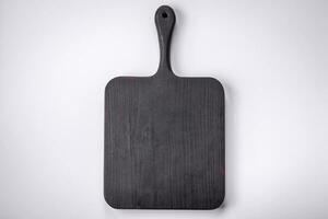 Empty wooden rectangular cutting board on a plain background, flatley with copy space photo