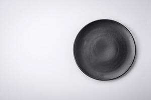 Empty round ceramic plate on a plain background, flatley with copy space photo