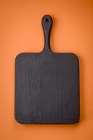 Empty wooden rectangular cutting board on a plain background, flatley with copy space photo