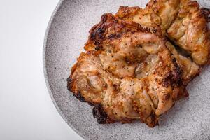 Delicious fresh crispy chicken grilled with salt, spices and herbs photo