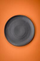 Empty round ceramic plate on a plain background, flatley with copy space photo