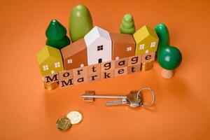 A small wooden house and keys as an idea for investing in your own home photo