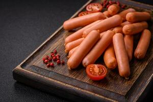 Delicious small sausages with salt, spices and herbs photo