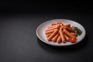 Delicious small sausages with salt, spices and herbs photo