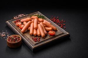 Delicious small sausages with salt, spices and herbs photo